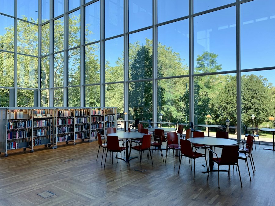 Library with tall windows and reading tables
